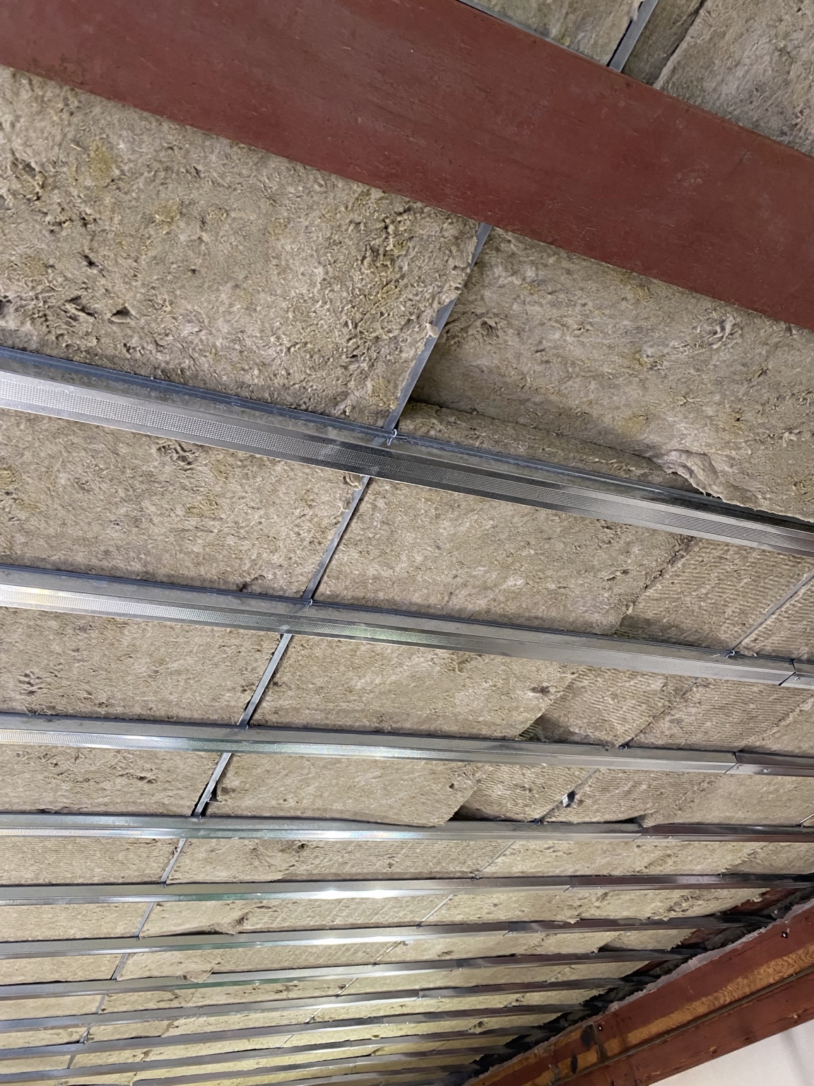 Acoustic insulation above commercial ceiling